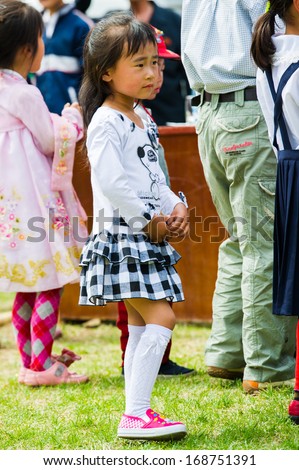 NORTH KOREA - MAY 1, 2012: Portrait of a Korean girl during the celebration of the International Worker\'s Day in N.Korea, May 1, 2012. May 1 is a national holiday in 80 countries