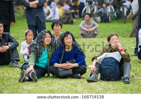 NORTH KOREA - MAY 1, 2012: Korean family during the celebration of the International Worker\'s Day in N.Korea, May 1, 2012. May 1 is a national holiday in 80 countries