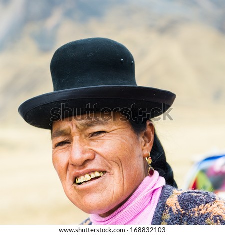 PERU - NOVEMBER 6, 2010: Unidentified Peruvian lady in the popular bowler hat walks the street in Peru, Nov 6, 2010. Over 50 per cent of people in Peru live below the the poverty line.