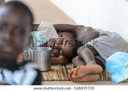 TOGO - MARCH 9, 2013: Togolese children sleep on the floor in Togo, Mar 9, 2013. Children in Togo suffer from poverty due to the unstable economical situation.