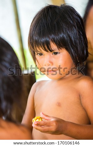 EMBERA VILLAGE, PANAMA, JANUARY 9, 2012: Unidentified native Indian boy in the Indian reservation in Panama, Jan 9, 2012. Indian reservation is the way to conserve native culture, languange, tradition