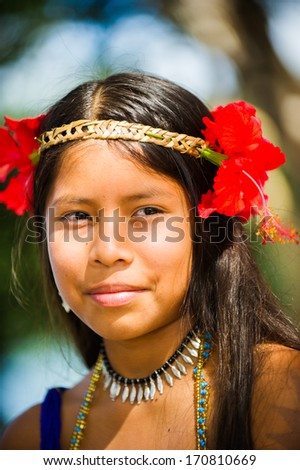 EMBERA VILLAGE, PANAMA, JANUARY 9, 2012: Portrait of an unidentified native Indian girl with flowers on head  in Panama, Jan 9, 2012.Indian reservation is the way to conserve native culture, languange