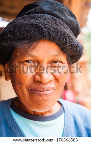 MADAGASCAR - JUNE 29, 2011: Unidentified Madagascar woman in a black hat smiles for camera in Madagascar, June 29, 2011. People of Madagascar suffer of poverty due to the unstable situation.
