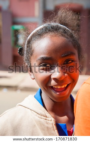 MADAGASCAR - JUNE 30, 2011: Unidentified Madagascar girl with curly hair in Madagascar, June 30, 2011. Children of Madagascar suffer of poverty due to the unstable situation.