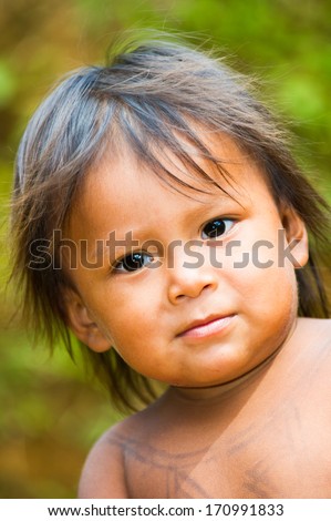 EMBERA VILLAGE, PANAMA, JANUARY 9, 2012: Portrait of an unidentified native Indian little playing in the jungle in Panama, Jan 9, 2012. Indian reservation is the way to conserve native culture