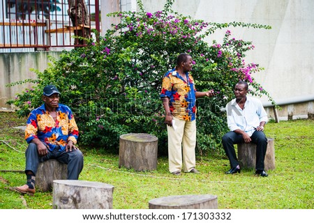GABON - MARCH 6, 2013: Three unidentified Gabonese men sit and talk of different things in Gabon, Mar 6, 2013. People of Gabon suffer of poverty due to the unstable situation