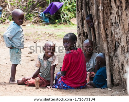 AMBOSELI, KENYA - OCTOBER 10, 2009: Unidentified Massai children playing at the tree in Kenya, Oct 10, 2009. Massai people are a Nilotic ethnic group