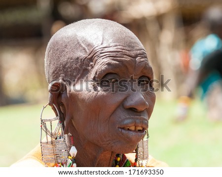 AMBOSELI, KENYA - OCTOBER 10, 2009: Portrait of an unidentified Massai extraordinary woman with heavy earrings in Kenya, Oct 10, 2009. Massai people are a Nilotic ethnic group
