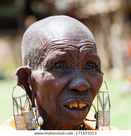 AMBOSELI, KENYA - OCTOBER 10, 2009: Portrait of an unidentified Massai extraordinary woman with heavy earrings in Kenya, Oct 10, 2009. Massai people are a Nilotic ethnic group