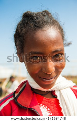 OMO VALLEY, ETHIOPIA - SEPTEMBER 19, 2011: Unidentified Ethiopian girl in a red jacket in Ethiopia, Sep.19, 2011. People in Ethiopia suffer of poverty due to the unstable situation
