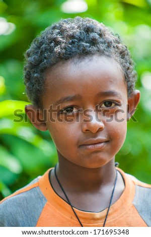 OMO VALLEY, ETHIOPIA - SEP 20, 2011: Unidentified Ethiopian boy in a  shirt poses for the camera in Ethiopia, Sep.20, 2011. People in Ethiopia suffer of poverty due to the unstable situation