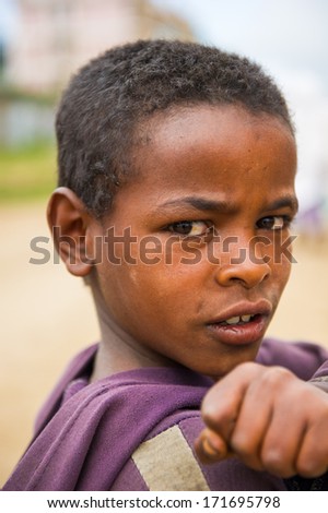 OMO VALLEY, ETHIOPIA - SEP 22, 2011: Unidentified Ethiopian boy poses for camera smiling in Ethiopia, Sep.22, 2011. People in Ethiopia suffer of poverty due to the unstable situation