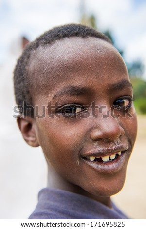 OMO VALLEY, ETHIOPIA - SEP 22, 2011: Unidentified Ethiopian boy poses for camera smiling in Ethiopia, Sep.22, 2011. People in Ethiopia suffer of poverty due to the unstable situation