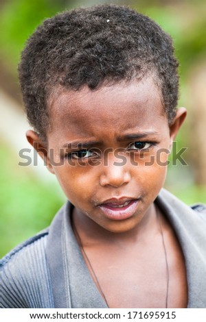OMO VALLEY, ETHIOPIA - SEP 22, 2011: Unidentified Ethiopian little boy looks on the camera Ethiopia, Sep.22, 2011. People in Ethiopia suffer of poverty due to the unstable situation