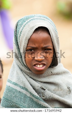 OMO VALLEY, ETHIOPIA - SEP 22, 2011: Unidentified Ethiopian girl covered by warm clothes in Ethiopia, Sep.22, 2011. People in Ethiopia suffer of poverty due to the unstable situation