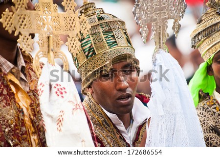 LALIBELA, ETHIOPIA - SEP 27, 2011: Unidentified Ethiopian religious man holds the golden cross and speaks during the Meskel festival in Ehtiopia, Sep 27, 2011. Meskel means finding of the True Cross