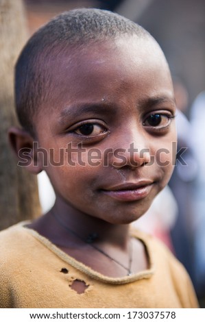 AKSUM, ETHIOPIA - SEP 27, 2011: Portrait of an unidentified Ethiopian cute girl in old clothes in Ethiopia, Sep.27, 2011. Children in Ethiopia suffer of poverty due to the unstable situation