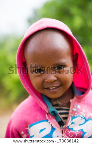 AKSUM, ETHIOPIA - SEP 24, 2011: Unidentified Ethiopian beautiful girl smiles for camera in Ethiopia, Sep.24, 2011. People in Ethiopia suffer of poverty due to the unstable situation