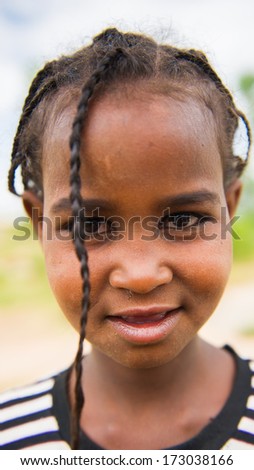 AKSUM, ETHIOPIA - SEP 24, 2011: Unidentified Ethiopian beautiful girl with pigtails smiles for camera in Ethiopia, Sep.24, 2011. People in Ethiopia suffer of poverty due to the unstable situation