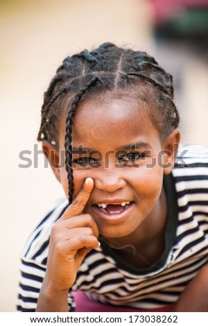 AKSUM, ETHIOPIA - SEP 24, 2011: Unidentified Ethiopian beautiful girl with pigtails smiles for camera in Ethiopia, Sep.24, 2011. People in Ethiopia suffer of poverty due to the unstable situation