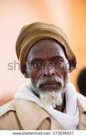 AKSUM, ETHIOPIA - SEP 24, 2011: Unidentified Ethiopian man ina yellow hat with white beard in Ethiopia, Sep.24, 2011. People in Ethiopia suffer of poverty due to the unstable situation