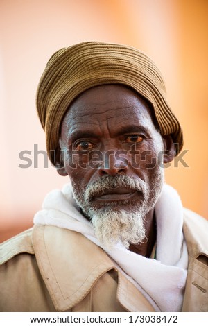 AKSUM, ETHIOPIA - SEP 24, 2011: Unidentified Ethiopian man ina yellow hat with white beard in Ethiopia, Sep.24, 2011. People in Ethiopia suffer of poverty due to the unstable situation