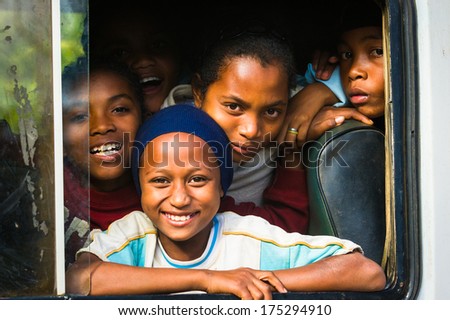 Antananarivo, Madagascar - June 27, 2011: Unidentified Madagascar Pupils Smile From A School Bus. People In Madagascar Suffer Of Poverty Due To The Slow Development Of The Country