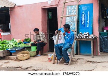ANTANANARIVO, MADAGASCAR - JUNE 29, 2011: Unidentified Madagascar man and woman work at the market. People in Madagascar suffer of poverty due to the slow development of the country