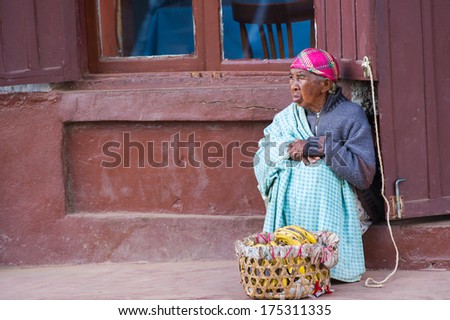 ANTANANARIVO, MADAGASCAR - JUNE 30, 2011: Unidentified Madagascar old lady sells bananas. People in Madagascar suffer of poverty due to the slow development of the country