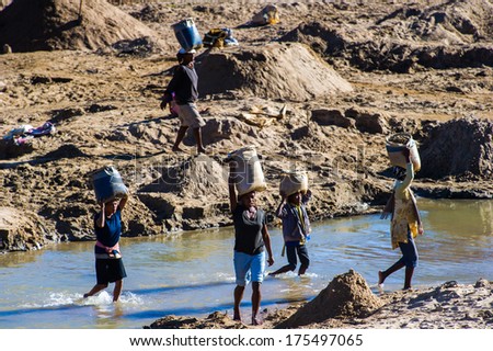Antananarivo, Madagascar - June 29, 2011: Unidentified Madagascar People Take Water From The River. People In Madagascar Suffer Of Poverty Due To The Slow Development Of The Country