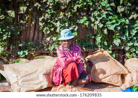 ANTANANARIVO, MADAGASCAR - JUNE 30, 2011: Unidentified Madagascar woman sits in the street.  People in Madagascar suffer of poverty due to slow development of the country