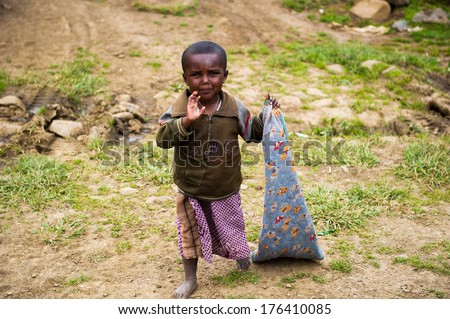 OMO, ETHIOPIA - SEPTEMBER 22, 2011: Unidentified Ethiopian boy runs in the street. People in Ethiopia suffer of poverty due to the unstable situation