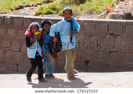 ANTANANARIVO, MADAGASCAR - JUNE 30, 2011: Unidentified Madagascar children walk from the school in the street. People in Madagascar suffer of poverty due to slow development of the country