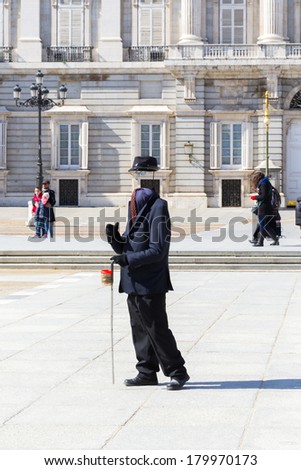 MADRID, SPAIN - MAR 4, 2014: Invisible man on the Square near the Palacio Real (Royal Palace), Madrid, Spain. Royal Palace is the official residence of the Spanish Royal Family
