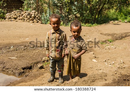 LALIBELA, ETHIOPIA - SEPTEMBER 28, 2011: Unidentified Ethiopian little friends play in the field. People in Ethiopia suffer of poverty due to the unstable situation