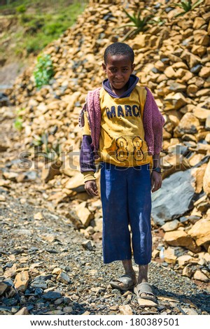 AKSUM, ETHIOPIA - SEPTEMBER 24, 2011: Unidentified Ethiopian boy wears old sport clothes. People in Ethiopia suffer of poverty due to the unstable situation