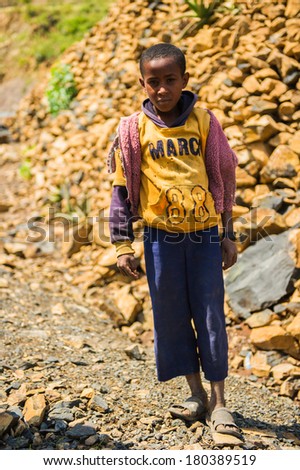 AKSUM, ETHIOPIA - SEPTEMBER 24, 2011: Unidentified Ethiopian boy wears old sport clothes. People in Ethiopia suffer of poverty due to the unstable situation