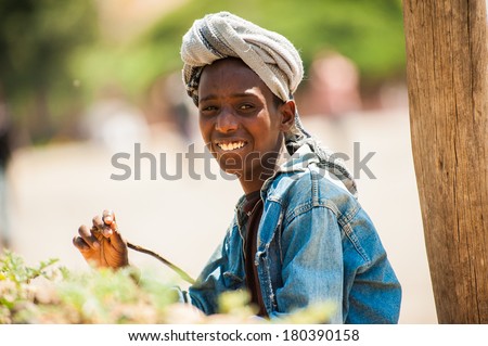 AKSUM, ETHIOPIA - SEPTEMBER 24, 2011: Unidentified Ethiopian boy in a turban smiles. People in Ethiopia suffer of poverty due to the unstable situation
