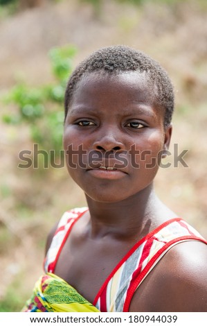 PORTO-NOVO, BENIN - MAR 8, 2012: Unidentified Beninese woman with short haircut. People of Benin suffer of poverty due to the difficult economic situation.