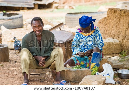 PORTO-NOVO, BENIN - MAR 8, 2012: Unidentified Beninese lman and woman work at the market. People of Benin suffer of poverty due to the difficult economic situation.