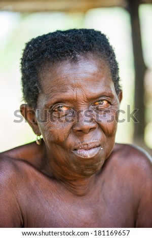 PORTO-NOVO, BENIN - MAR 8, 2012: Portrait of unidentified Beninese sympathic old woman. People of Benin suffer of poverty due to the difficult economic situation.