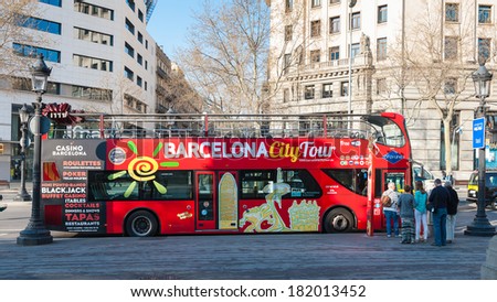 BARCELONA, SPAIN - MAR 15, 2014: Narcelona City Tour bus on the Plaza Catalnya (Catalonia Square). The Plaza occupies an area of about 50,000 m2 and it\'s considered to be the center of the city.