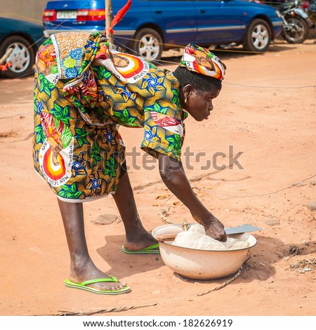 PORTO-NOVO, BENIN - MAR 9, 2012: Unidentified Beninese woman sells goods at the local market. People of Benin suffer of poverty due to the difficult economic situation.