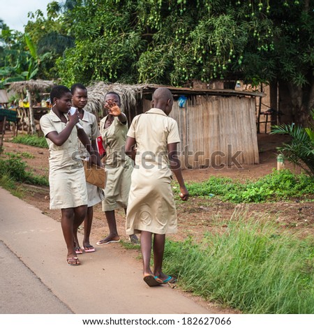 PORTO-NOVO, BENIN - MAR 9, 2012: Unidentified Beninese women walk and talk near the road. People of Benin suffer of poverty due to the difficult economic situation.