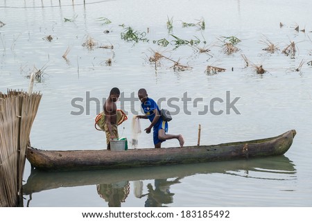 PORTO-NOVO, BENIN - MAR 9, 2012: Unidentified Beninese men go fishing. Children of Benin suffer of poverty due to the difficult economic situation