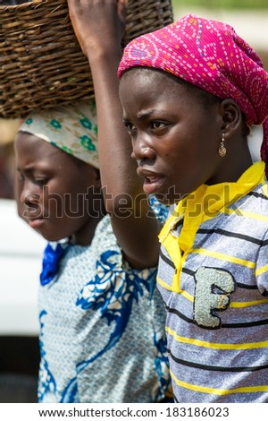 PORTO-NOVO, BENIN - MAR 9, 2012: Unidentified Beninese people at the local market. People of Benin suffer of poverty due to the difficult economic situation
