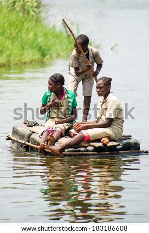 PORTO-NOVO, BENIN - MAR 9, 2012: Unidentified Beninese people in the water. People of Benin suffer of poverty due to the difficult economic situation.