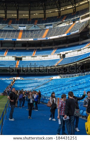 MADRID, SPAIN - MAR 11, 2014: Unidentified tourists near the bench of Real Madrid at the Santiago Bernabeu stadium. Santiago Bernabeu is a home arena for the Real Madrid Club de Futbol
