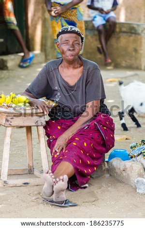 PORTO-NOVO, BENIN - MAR 10, 2012: Unidentified Beninese local woman sells bananas. People of Benin suffer of poverty due to the difficult economic situation