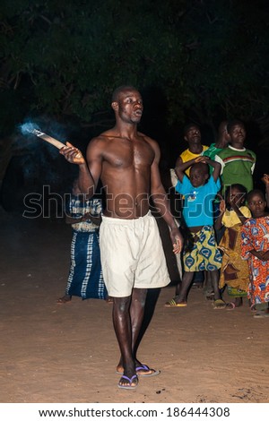 LOME, TOGO - MAR 7, 2012: Unidentified Togolese man eats fire for the fire show performance. People in Togo suffer of poverty due to a difficult economical situation